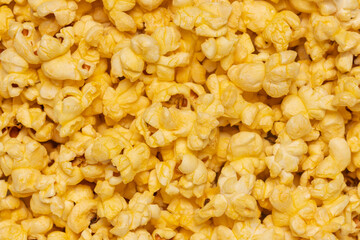 Top view of yellow buttered popcorn background