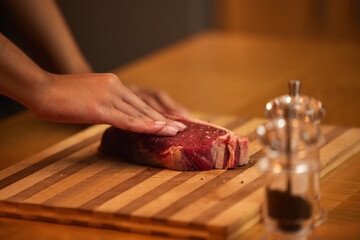 Kitchen, cooking and hands of person with steak for meal preparation at lunch, dinner and supper....
