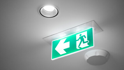 Green emergency exit sign or fire exit sign showing the way to escape with arrow symbol. - 791348268