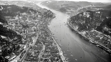 A black and white photo of a city with a river running through it