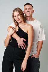 A Man and a Woman Standing Next to Each Other in studio