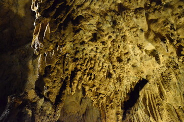 Creepy Underground cave. Eerie atmosphere inside the dark cave. Beams of light piercing through the...