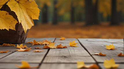 Autumn leaves scattered on a empty wooden table surface