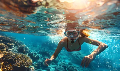 Muurstickers An azure water swimmer explores coral reef ecosystem underwater © Nadtochiy