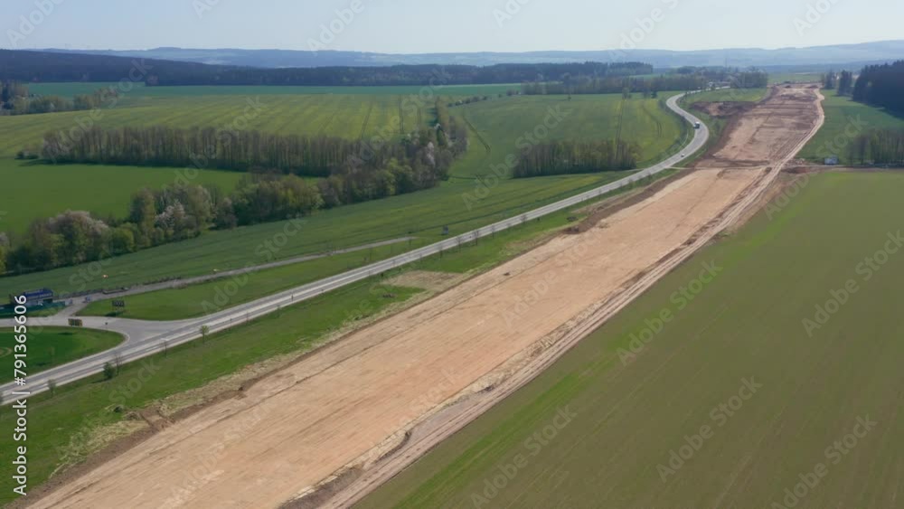 Poster spectacular aerial perspectives of an extensive highway project in progress, capturing the scale of 
