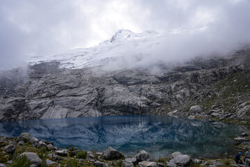 Mountain Lake covered in Mist. Turquoise Water in font of a Snow-Covered Peak - Huaraz, Peru...