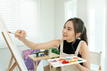 beautiful female hobbies about artist and use paintbrush in abstract art for create masterpiece....