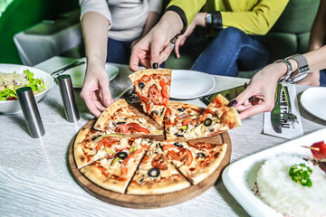 Group of People Enjoying Pizza Together at Table