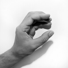 Letter C in American Sign Language (ASL) for deaf people, black and white monochrome photo of a hand
