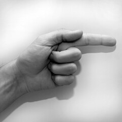 Letter G in American Sign Language (ASL) for deaf people, black and white photo of a hand