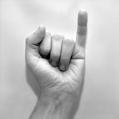 Letter I in American Sign Language (ASL), black and white photo of a hand