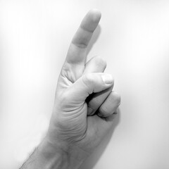 Letter Z in American Sign Language (ASL) for deaf people, black and white photo of a hand