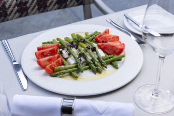 Caprese salad with asparagus served on a plate in the restaurant - 791378683