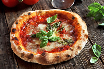 Neapolitan pizza with mozzarella, tomatoes and basil leaves.
Homemade pizza margherita. Selective focus