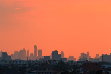 Background sky orange with cityscape of building silhouette,At twilight in Bangkok