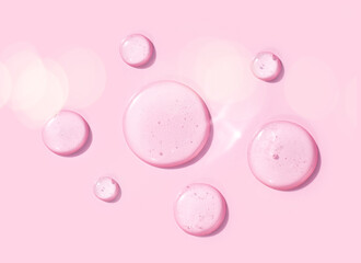 sample of cosmetic products toner serum round drops on a light pink background