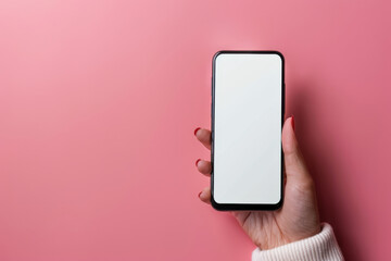 Woman hand holding a smartphone with a pink background, mockup mobile phone screen.