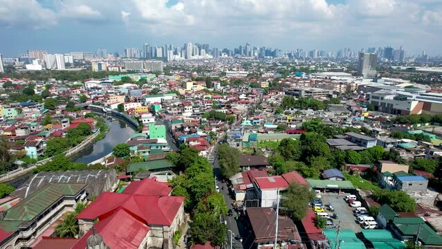 Taguig, Metro Manila, Philippines - Aerial of The Saint Anne Parish Church, also known as Santa Ana Church, with the BGC skyline in the horizon.