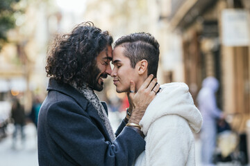 Affectionate gay couple embracing in city street
