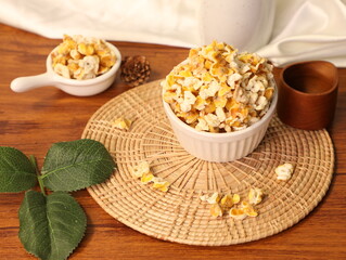 Popcorn for a plate and a cup of dipping sauce