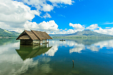 Beautiful Lake Batur landscape overlooking serene and beautiful Mount Batur during blue sky cloudy...