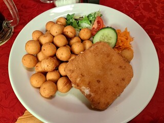 Fried cheese with croquette potatoes and vegetable 
