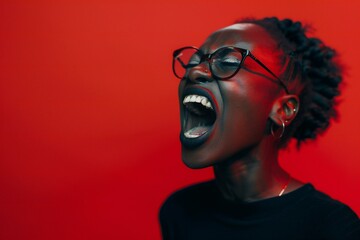 Portrait of a beautiful young african american woman with glasses on a red background
