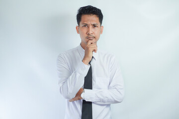 Young Asian man wearing white shirt showing thinking gesture