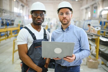 Two Heavy Industry Engineers Stand in Factory