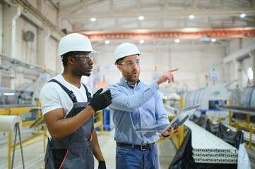 Two Heavy Industry Engineers Stand in Factory - obrazy, fototapety, plakaty