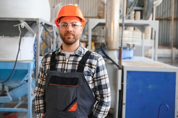 Portrait of factory worker. Young handsome factory worker