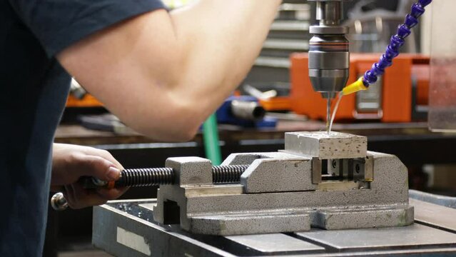 Pillar Drilling Machine Boring Hole On Metal Block In Manufacturing Industry. closeup shot