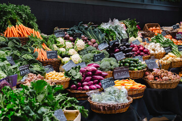 Fresh vegetables arranged in wicker baskets at market