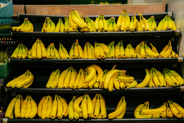 Organic fresh yellow bananas arranged in shelves at supermarket