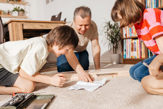 Man looking at instructions for assembling furniture