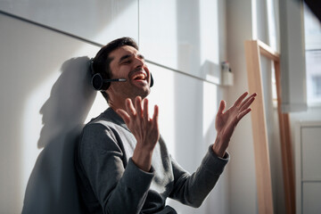 Cheerful mature businessman talking on headset
