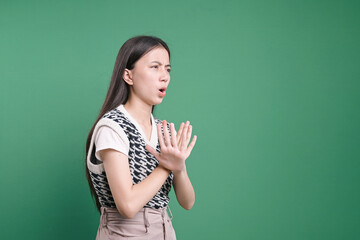 Side view of young woman showing cross hands gesture, demonstrating denial sign, rejecting...