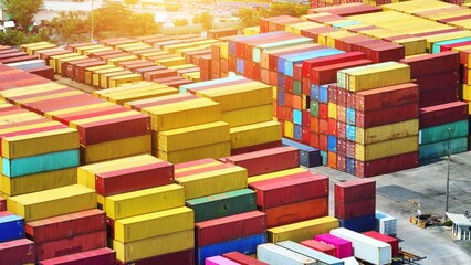 An expansive canvas of container yard sprawls, alive with colorful stacks of cargo containers....