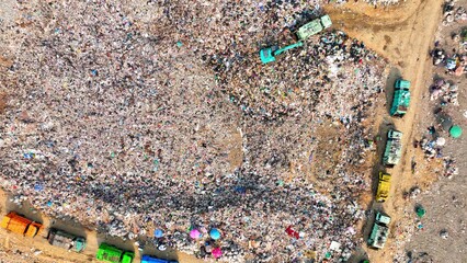 Aerial snapshot unveils the grim reality: Landfill sprawls with towering heaps of refuse,...