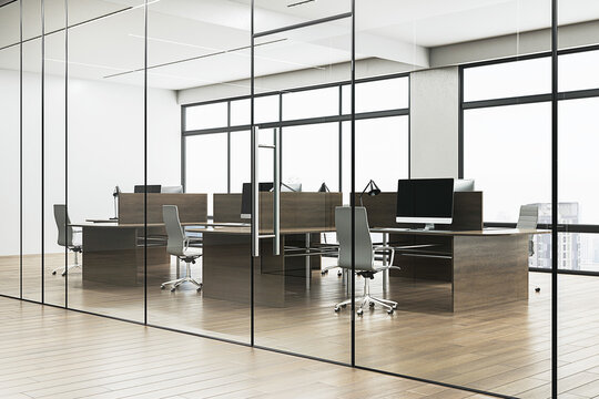 Modern office interior with glass partitions, wooden desks, chairs, and monitors, city skyline in the background, conveying a corporate workspace concept. 3D Rendering
