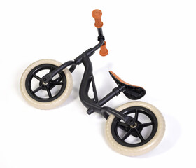 Used modern black balace bike for a small child, isolated