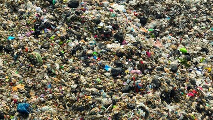 From above, a landfill sprawls a tapestry of refuse, a myriad of hues and textures. Each item tells a story of consumption. This intricate landscape underscores the challenge of waste management.
