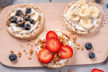 Rice Crackers Healthy Snack, Crackers Topped with Banana, Fresh Berries, Yogurt and Granola, Breakfast Idea