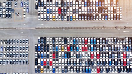 The aerial perspective unveils a meticulously arranged parking lot, a testament to automotive...