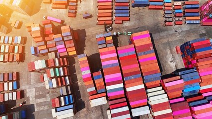 From above, a mesmerizing sight unfolds, vibrant cargo containers stacked in perfect alignment,...
