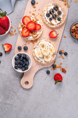 Rice Crackers Healthy Snack, Crackers Topped with Banana, Fresh Berries, Yogurt and Granola, Breakfast Idea
