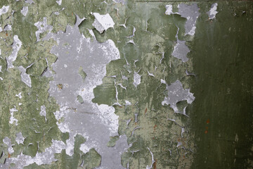 Peeling paint on the wall. Old concrete wall with cracked flaking paint. Weathered rough painted surface with patterns of cracks and peeling. Grunge texture for background and design. High resolution. - 791430606