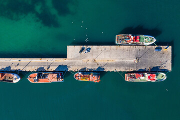 Top view, boats and harbour with ocean, port and marina for travel or cruise holiday. High angle,...