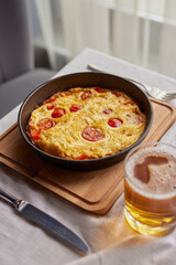 shakshuka in a frying pan, omelette, scrambled eggs with mushrooms in a frying pan, breakfast concept