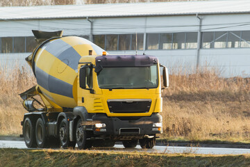 Construction machinery. A Cement mixer truck is delivering liquid concrete to the construction site